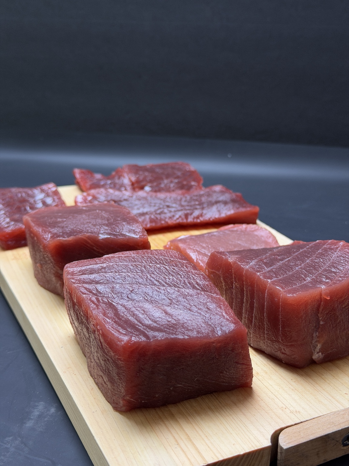 Premium tuna cuts arranged on a wooden board